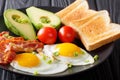 Healthy traditional breakfast of fried eggs with bacon, fresh av Royalty Free Stock Photo