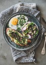 Healthy trendy breakfast with avocado toast, fried egg and salad Royalty Free Stock Photo