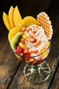 Healthy tropical fruit salad with whipped cream Royalty Free Stock Photo