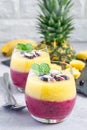 Healthy two layer smoothie for breakfast in glass, vertical
