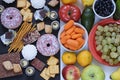 Healthy and unhealthy food concept, fruits and vegetables vs donuts, sweets and chocolate with woman`s hand. Top view Royalty Free Stock Photo