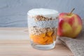 Healthy vanilla pudding of a chia in a glass with granola and a mango