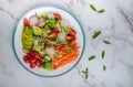 Healthy vegan bowl. Avocado, tomato, Red Radish,carrot, Sunflower seedling,Black pepper, lemon, and vegetables salad. Top view.