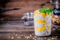 Healthy vegan breakfast, chia pudding with mango and granola in the jar on wooden background Royalty Free Stock Photo