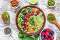 Healthy vegan breakfast. matcha green tea smoothie bowl with fresh fruits, berries, nuts, seeds and granola. top view Royalty Free Stock Photo