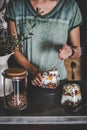 Woman having healthy breakfast with yogurt, granola, fruits in glass Royalty Free Stock Photo