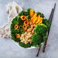 Healthy vegan buddha bowl with kale leaves and raw vegetables