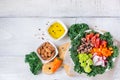 Healthy vegan buddha bowl with kale leaves and raw vegetables Royalty Free Stock Photo