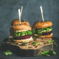 Healthy vegan burger with beetroot-quinoa patty and arugula, square crop