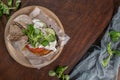 Healthy vegan burger with fresh vegetables and yogurt sauce on rustic kitchen counter top Royalty Free Stock Photo