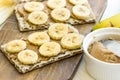 Healthy vegan dessert homemade peanut butter and banana sandwich with Swedish whole grain crispbread, breakfast, kitchen table Royalty Free Stock Photo