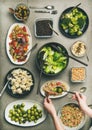 Healthy vegan dishes and woman hands taking couscous from plate