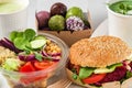 Healthy vegan food delivery. Buddha bowl salad, burger, soup, dessert and matcha latte packed in boxes and cups