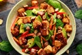 Healthy Vegan Fried Tofu salad with carrot, red bell pepper, spinach and nuts Royalty Free Stock Photo