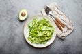 Healthy vegan green avocado salad bowl with sliced cucumbers, edamame beans, olive oil and herbs on ceramic plate top Royalty Free Stock Photo