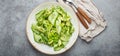 Healthy vegan green avocado salad bowl with sliced cucumbers, edamame beans, olive oil and herbs on ceramic plate top Royalty Free Stock Photo