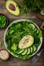 Healthy vegan green salad with avocado, broccoli, cucumber, green peas and spinach in white  bowl Royalty Free Stock Photo