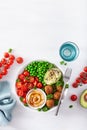 Healthy vegan lunch bowl with falafel hummus tomato avocado peas