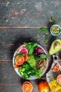 Healthy vegan lunch Buddha bowl avocado, blood orange, broccoli, watermelon radish, spinach, quinoa, pumpkin seeds. Balanced food Royalty Free Stock Photo