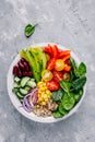 Healthy vegan lunch Buddha bowl. Avocado, quinoa, tomato, cucumber, red beans, spinach, red onion and red paprika vegetables salad Royalty Free Stock Photo