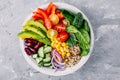 Healthy vegan lunch Buddha bowl. Avocado, quinoa, tomato, cucumber, red beans, spinach, red onion and red paprika vegetables salad Royalty Free Stock Photo