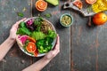 Healthy vegan lunch - buddha bowl of vegetables avocado, blood orange, broccoli, watermelon radish, spinach, quinoa, pumpkin seeds Royalty Free Stock Photo