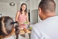 Healthy, vegan mother and family with a salad for lunch, meal or eating together at the kitchen table at home. Mom, dad Royalty Free Stock Photo