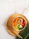 Healthy Vegan Poke bowl raw salad, heura vegetable protein, vegan chicken with variety vegetables, served in bowl on tropical Royalty Free Stock Photo