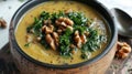 Healthy vegan soup with kale, beans, and walnuts in a ceramic bowl
