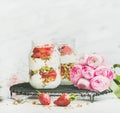 Healthy vegan spring breakfast jars with pink raninkulus flowers