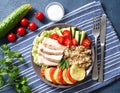 Healthy vegetable buddha bowl lunch with turkey, vegetables and quinoa on blue background. Top view.