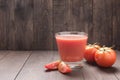 Healthy vegetable. Glass of red tomato juice on wooden table Royalty Free Stock Photo