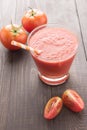 Healthy vegetable. Glass of red tomato juice on wooden table Royalty Free Stock Photo