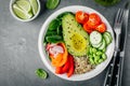 Healthy vegetable lunch Buddha bowl. Avocado, quinoa, tomatoes, cucumbers, radishes, spinach, carrots, paprika and edamame beans s Royalty Free Stock Photo