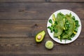 Healthy vegetable pancake. Spinach pancakes served with cucumber, avocado and greenery on dark wooden background top Royalty Free Stock Photo