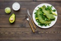 Healthy vegetable pancake. Spinach pancakes served with cucumber, avocado and greenery on dark wooden background top Royalty Free Stock Photo