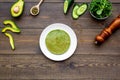 Healthy vegetable pancake. Spinach pancakes served with cucumber, avocado and greenery on dark wooden background top Royalty Free Stock Photo