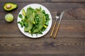 Healthy vegetable pancake. Spinach pancakes served with cucumber, avocado and greenery on dark wooden background top Royalty Free Stock Photo