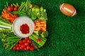 Healthy vegetable platter with football ball for american football game party. Close up Royalty Free Stock Photo