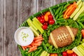 Healthy vegetable platter with meatloaf like a football ball for american football game party. Close up