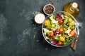 Healthy vegetable salad of fresh tomato, cucumber, onion, spinach, lettuce and pumpkin seeds in bowl. Diet menu. Top view with cop