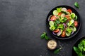 Healthy vegetable salad of fresh tomato, cucumber, onion, spinach, lettuce and sesame on plate. Diet menu Royalty Free Stock Photo