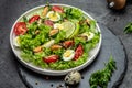 Healthy vegetable salad with mussels, mussels, quail, egg, conjugate, lime, spinach, lettuce, cherry tomatoes and microgreen. Diet