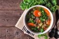 Healthy vegetable soup with kale and lentils. Above view table scene on wood. Royalty Free Stock Photo