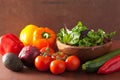 Healthy vegetables pepper tomato salad onion avocado on rustic b Royalty Free Stock Photo