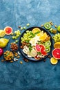 Healthy vegetarian bowl dish with fresh fruits and nuts. Plate with raw apple, orange, grapefruit, banana, kiwi, lemon, grape, alm Royalty Free Stock Photo