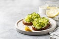 Healthy vegetarian breakfast with cucumber sandwiches with soft cheese and lemon water on gray background with text