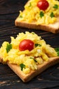 Healthy vegetarian breakfast . Scrambled eggs toast with cherry tomatoes and parsley Royalty Free Stock Photo