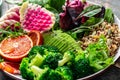 Healthy vegetarian buddha bowl salad with vegetables, avocado, blood orange, broccoli, watermelon radish, spinach, quinoa, pumpkin Royalty Free Stock Photo