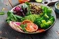 Healthy vegetarian buddha bowl salad with vegetables, avocado, blood orange, broccoli, watermelon radish, spinach, quinoa, pumpkin Royalty Free Stock Photo
